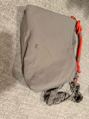 lululemon athletica taupe crossbody with bright orange cord detail